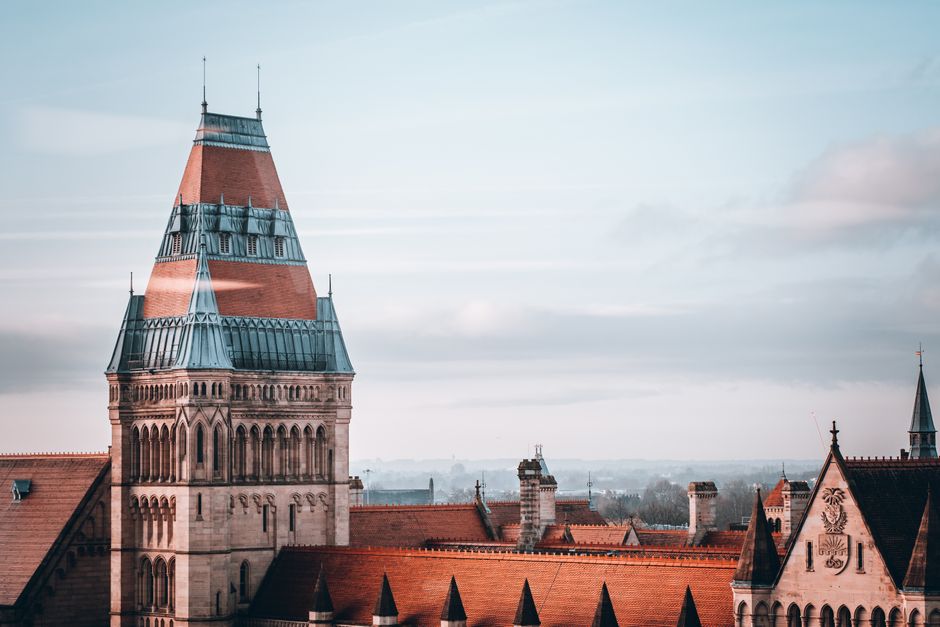 Elegant view of the University of Manchester tower with its iconic architecture and surrounding rooftops.