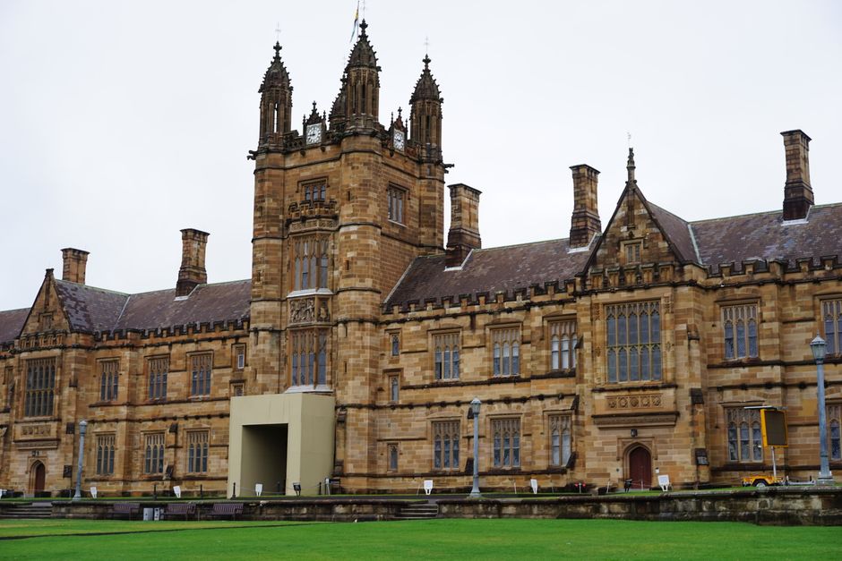 Front view of a historic university building with gothic architecture.